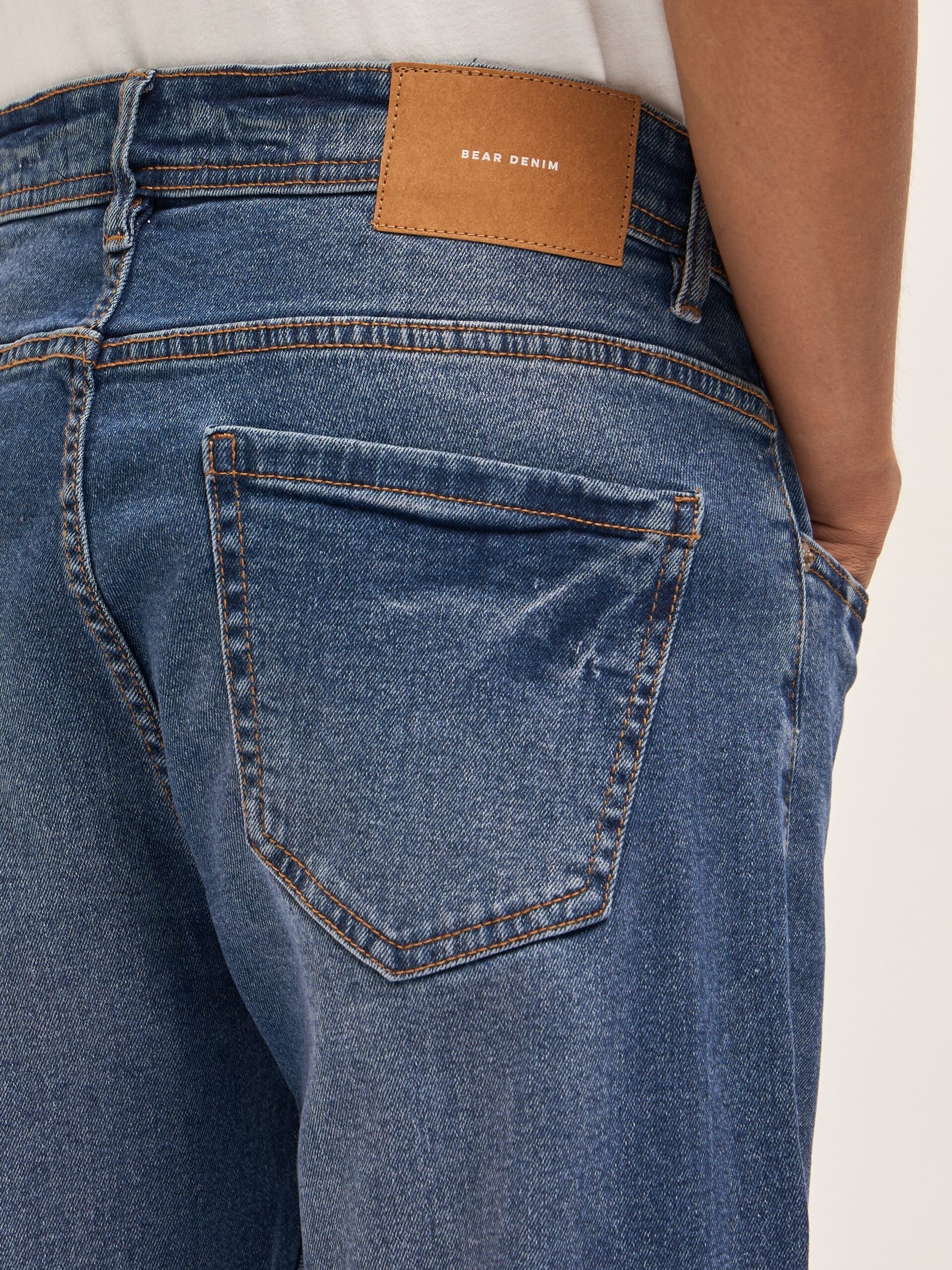 mid blue mid rise slim fit jeans with lightly distressed mid blue mid rise slim fit jeans with lightly distressed