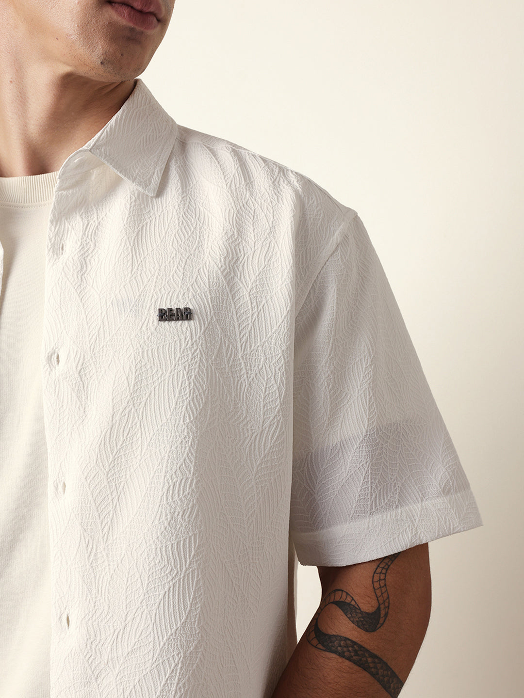 white all over textured leaf motif oversized shirt with half sleeves white all over textured leaf motif oversized shirt with half sleeves
